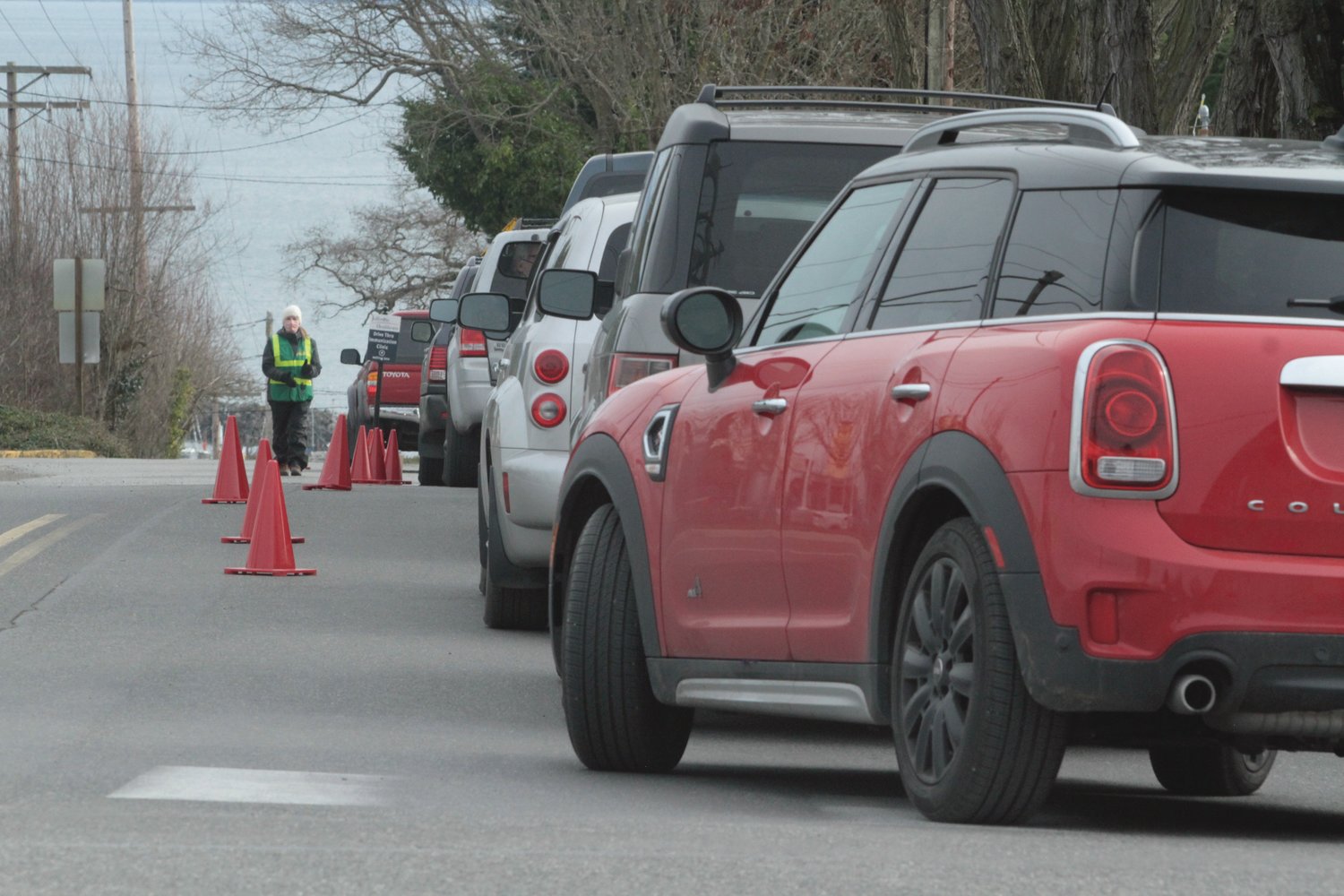 Drivers wait in a queue for COVID-19 vaccinations outside Jefferson Healthcare Friday in Port Townsend.