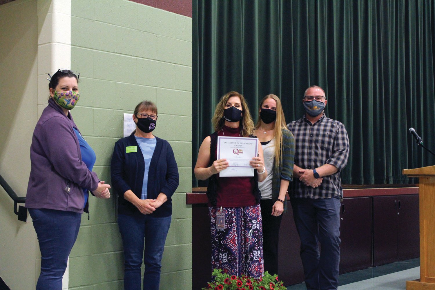 Jessica Gossette, Cindy Pollard, Kimberly Knudson, Trisha Freiberg, Frank Redmon pose for a photo after Knudson was awarded the Excellence in Education Award during a recent ceremony.