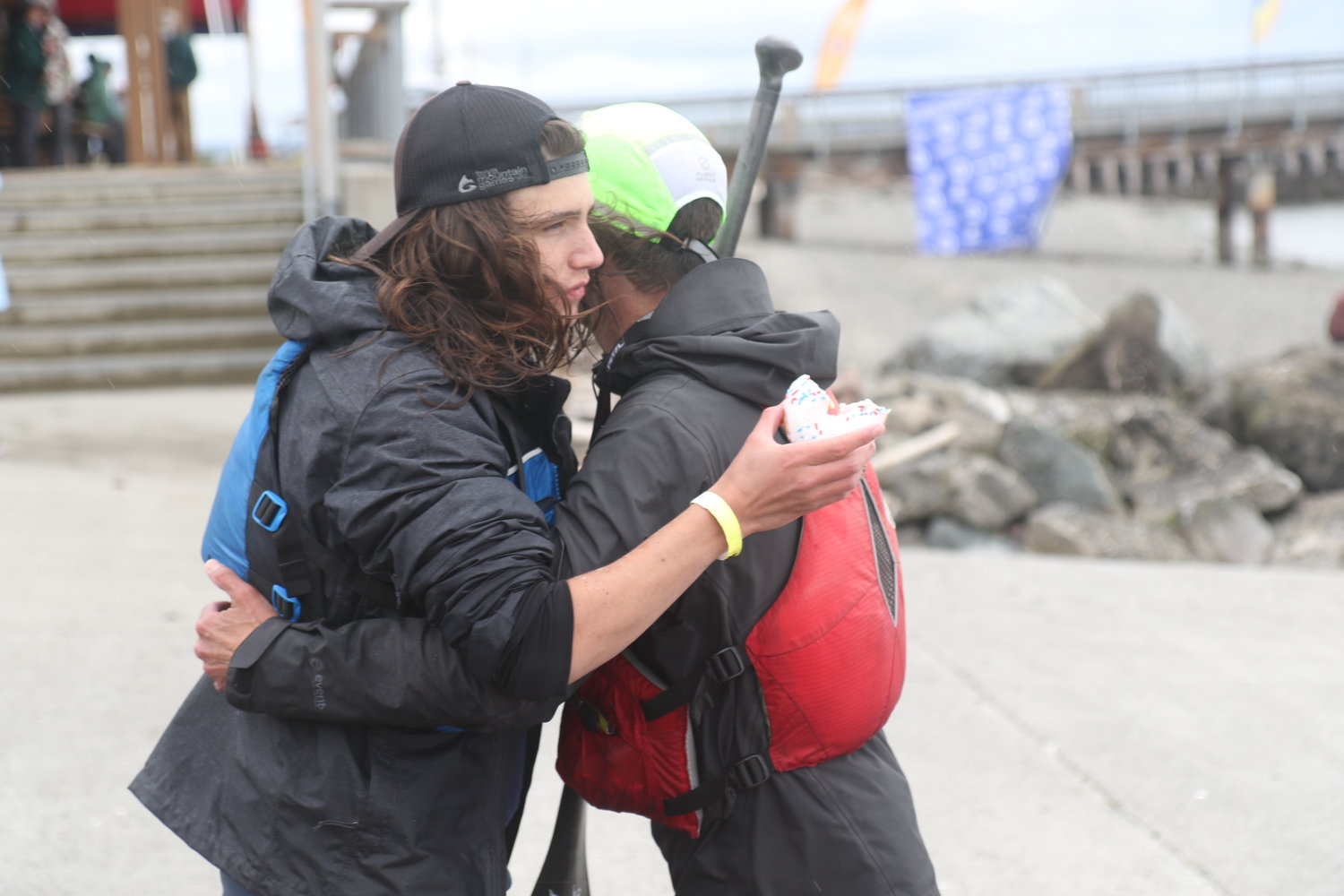 Owen and Brook Swanson hug, donuts in-hand, shortly after arriving at the Northwest Maritime Center and completing the 70-mile Seventy48 race.
