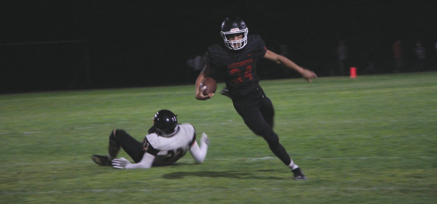 Rivals running back Logan Massie dashes past a Tiger defender during Friday’s season opener.
