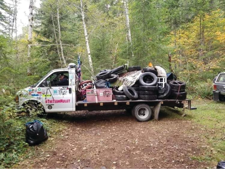 A Gambler 500 racer hauls out a load of tires that had been dumped in the Olympic National Forest.