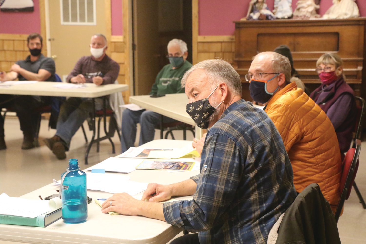 Port of Port Townsend executive director Eron Berg, (in orange) and Port deputy director Eric Toews led a two-hour open community meeting in Quilcene last week to hear the local community’s concerns surrounding Herb Beck Marina.