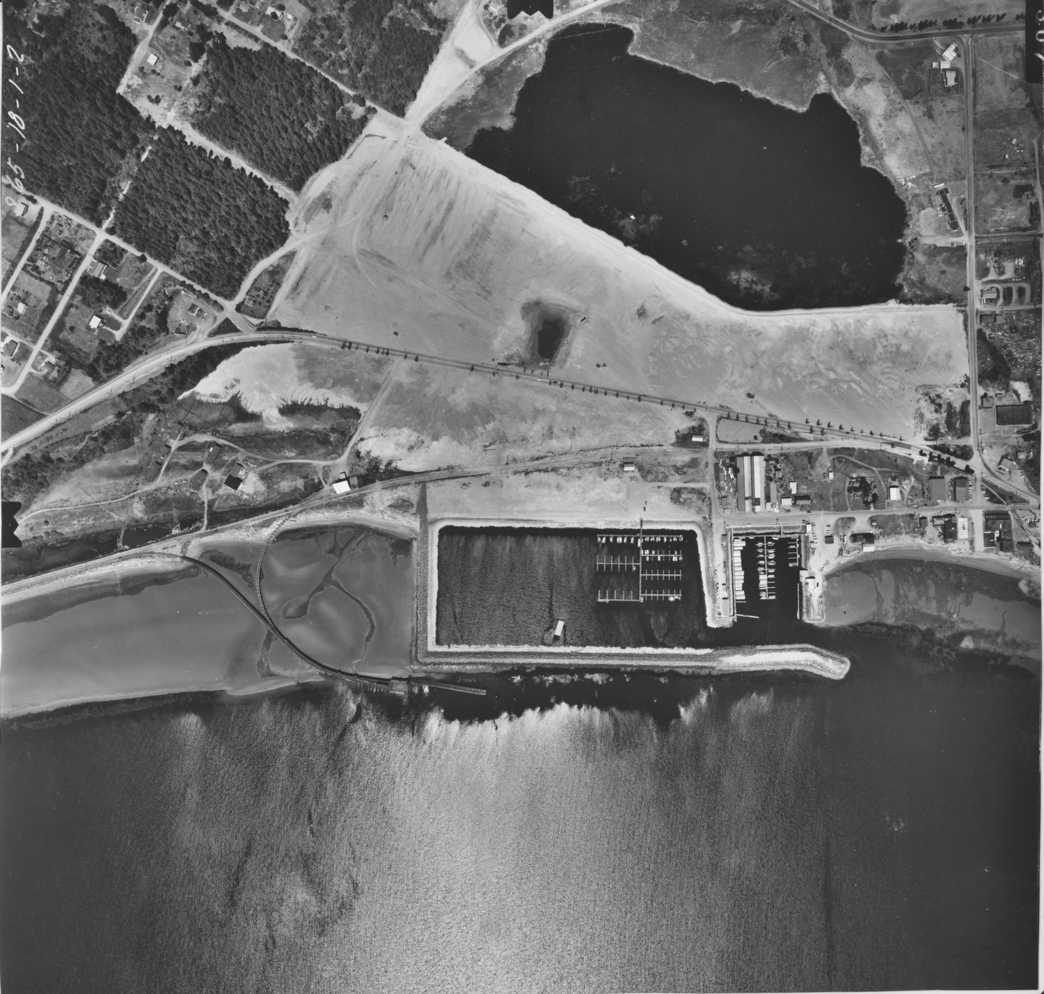 An aerial high-resolution image of Kah Tai in 1965 after the USACE dredging operation began in 1963 to expand the Boat Haven at the bottom of the photo.