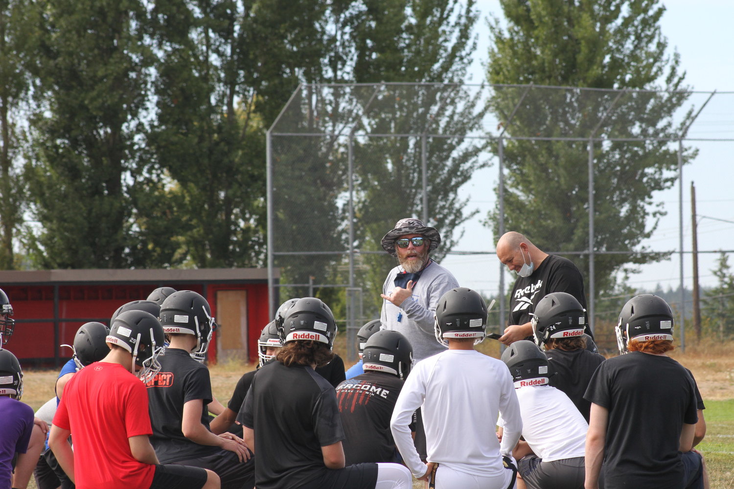 Head Coach Tony Haddenham instructs his players in a preseason practice during the summer.
