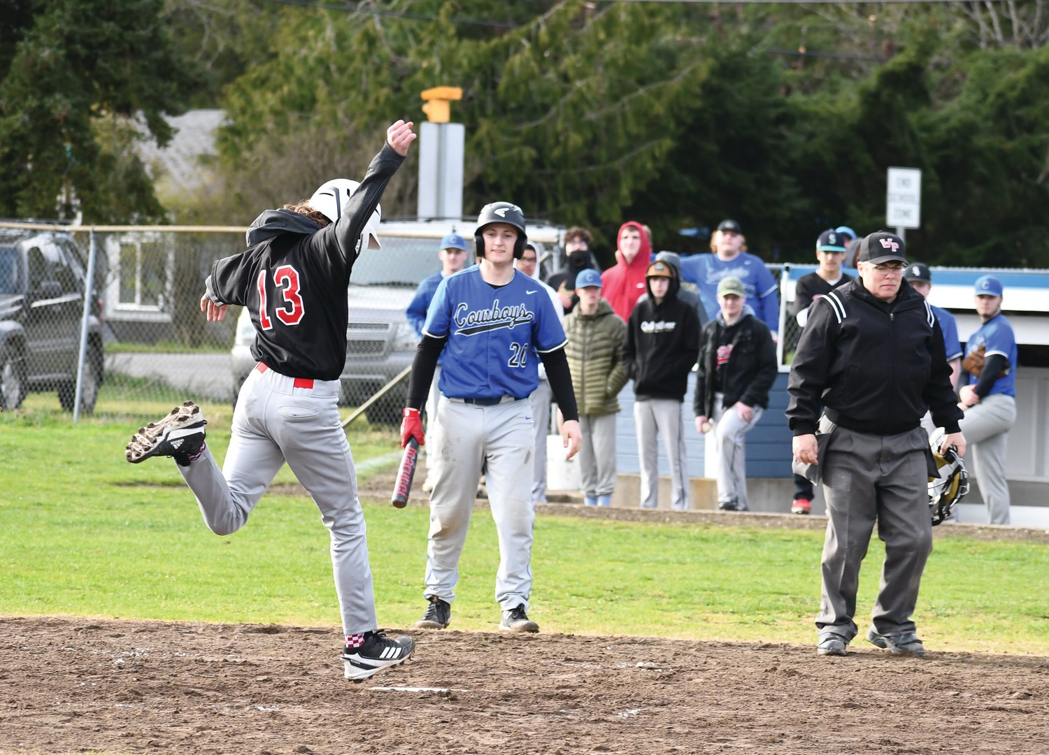 EJ’s Nathan Nisbet steps on home plate to score a run in the fifth inning. Teammate Sean Jones watches, proceeding to congratulate Nisbet shortly after.