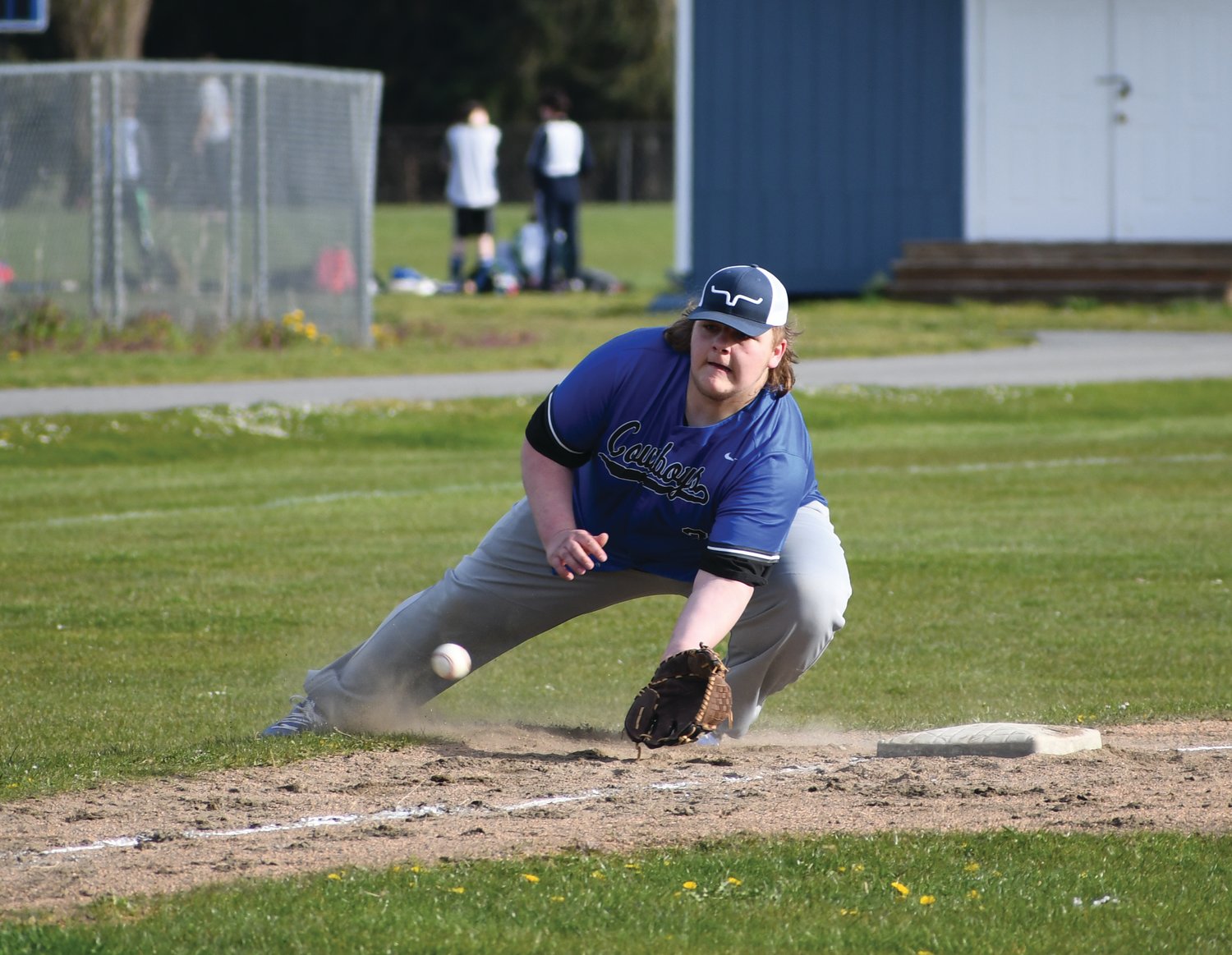 Third baseman Chris Fair collects a ball traveling down the foul line. Leader photo by James Sloan
