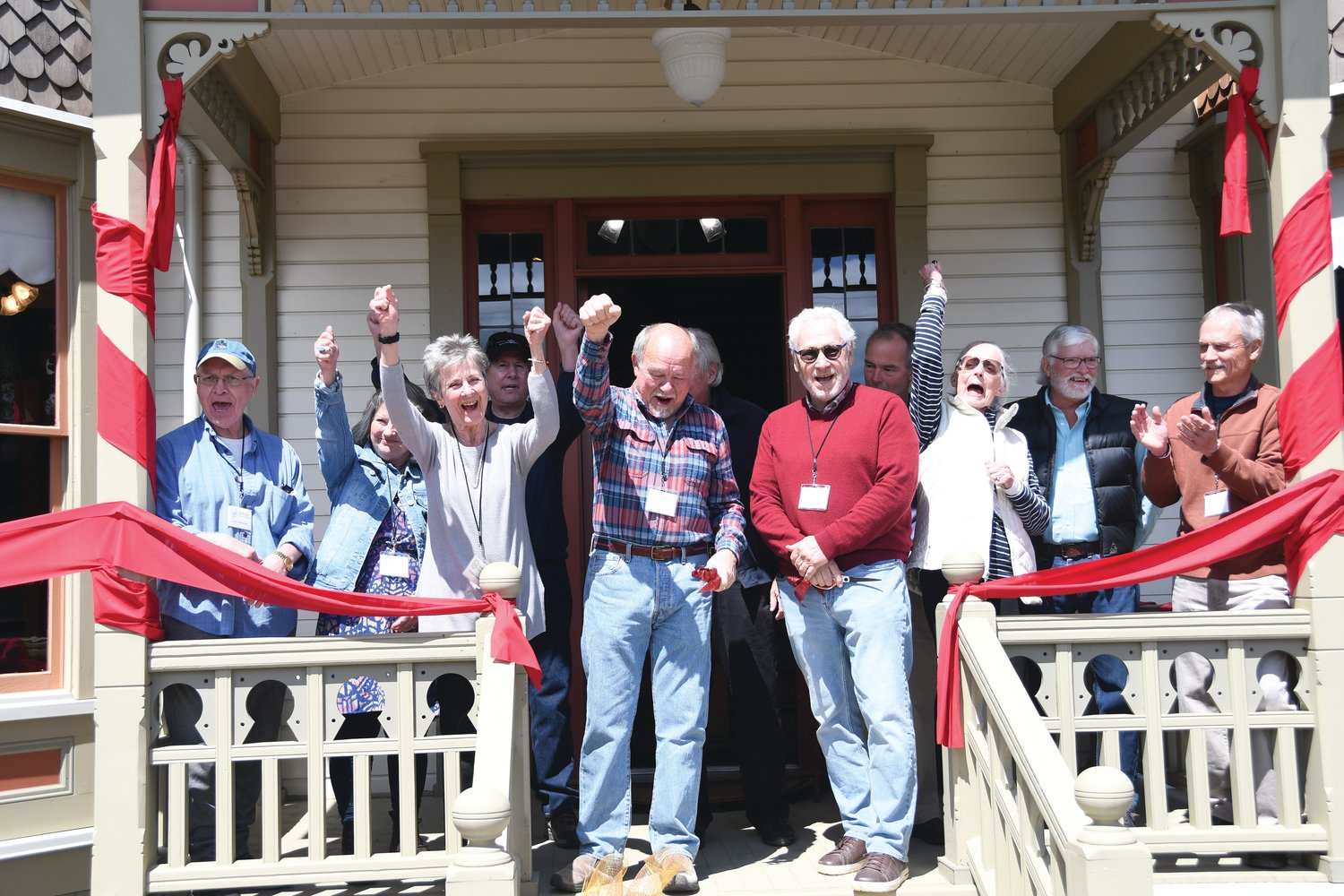 Board members of the Quilcene Historical Museum celebrate the Worthington Mansion’s grand opening Friday with a “hip hip hooray” celebration following an 11-year restoration of the property.