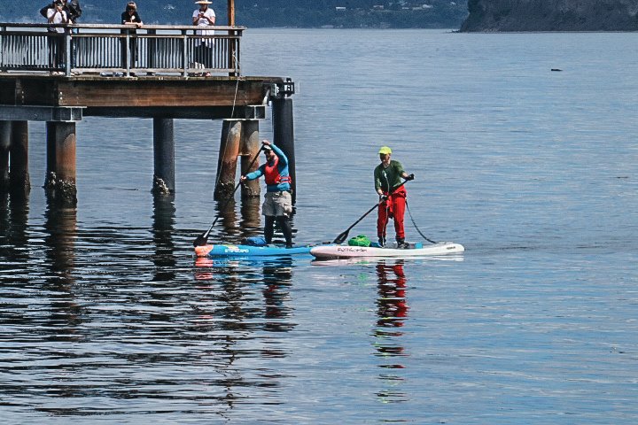 Seattle residents Sam Hendrix (Team Bogus Journey) and Adam Tischler (Team Big Mouth Strikes Again) paddle their way to the finish line in Port Townsend Bay during the fourth annual Seventy 48 water race.