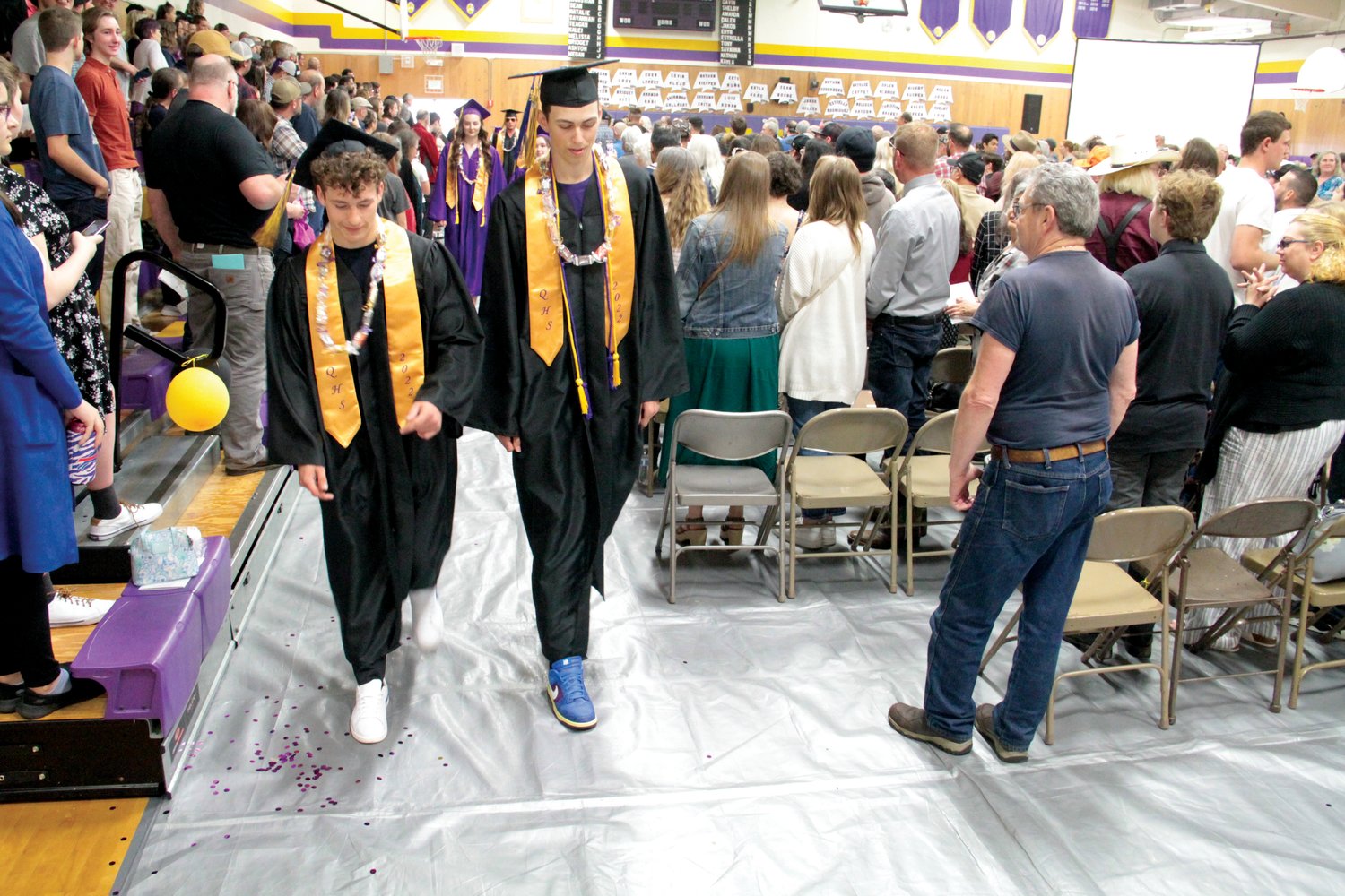 Kevin Alejo and Nathan Kieffer walk through the gymnasium during the procession at Quilcene’s graduation ceremony Saturday.