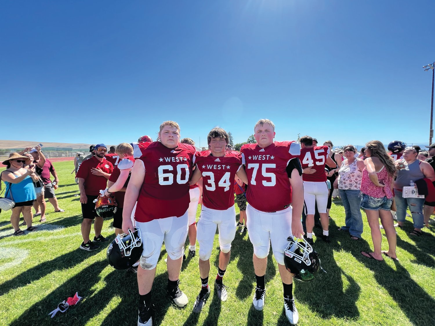 Rivals seniors Chris Fair, Logan Massie, and Marshall Graves pose together after the Earl Barden Classic all-star football game in Yakima this past weekend.