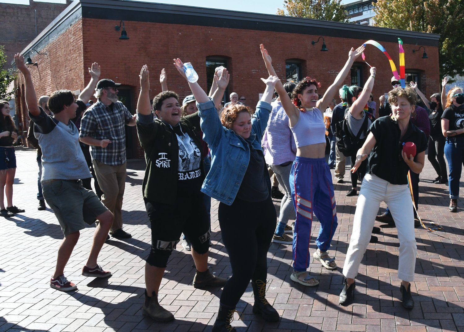 Counter protesters dance and sing to “Y.M.C.A” by Village People to show solidarity for the Olympic Peninsula YMCA.