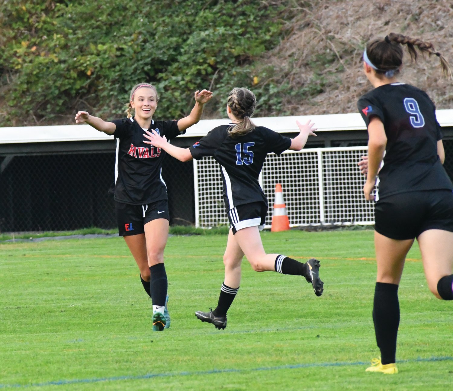 Junior midfielder Iris Mattern celebrates with teammates Ava Shiflett and Kaylen Pray after scoring her first goal of the game in the opening half.