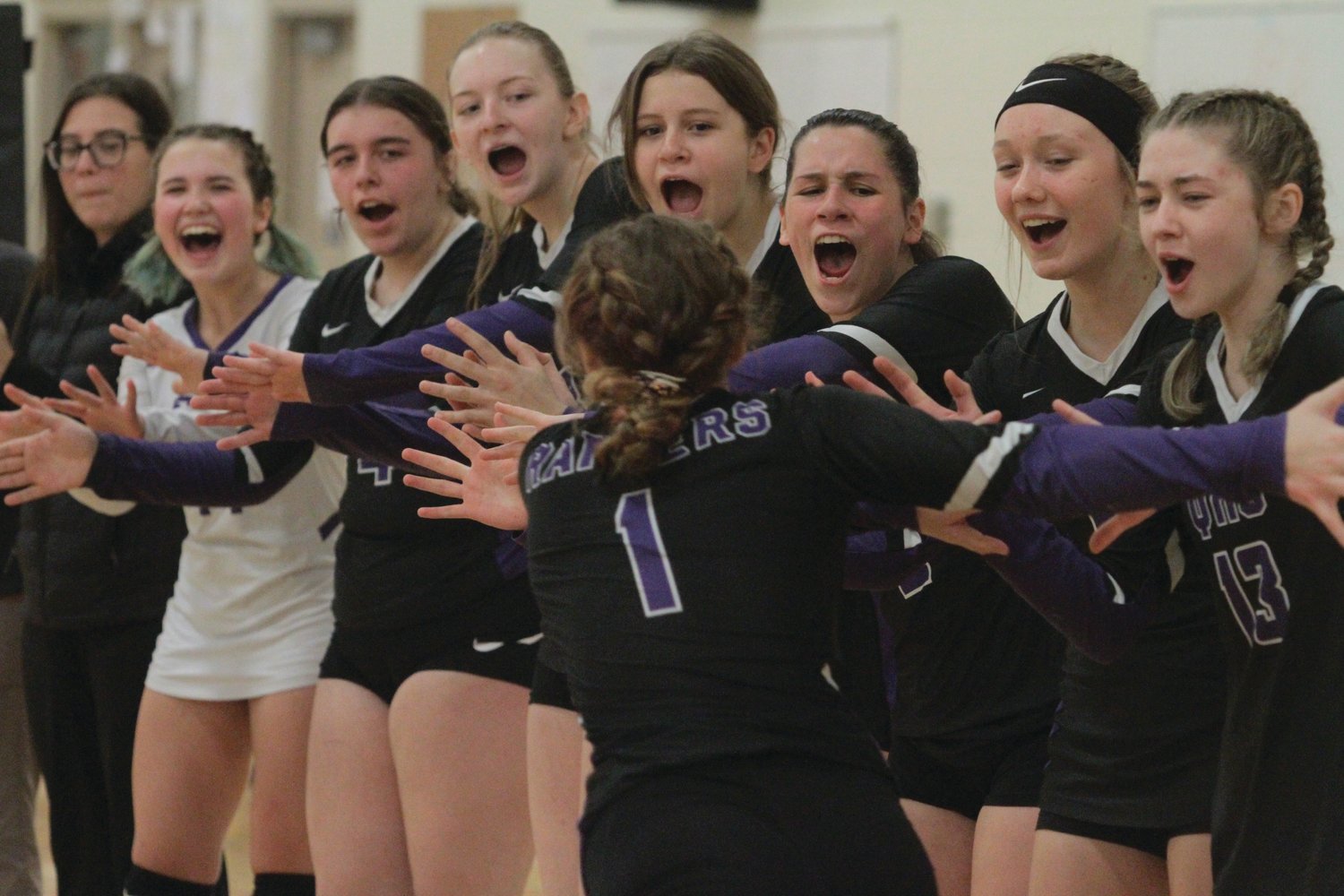 Abigail Ward gets an enthusiastic sendoff from her teammates as the starters are introduced in the district tournament.