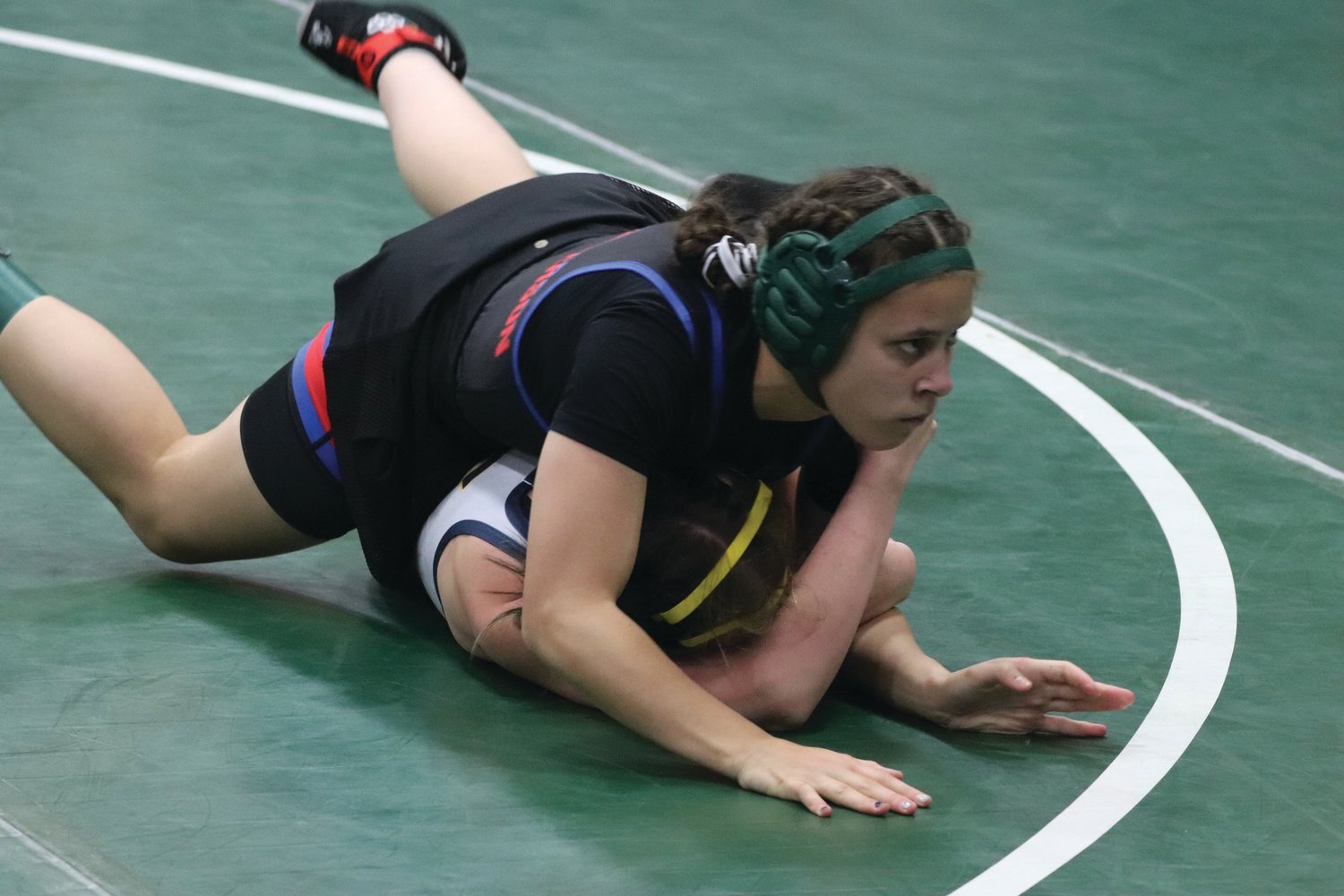 Junior Mi Amada Lanphear Ramirez, who competed at the state tournament in her first year of competitive wrestling, balances on her Forks High opponent and her hands, waiting for the opportunity to apply uncomfortable pressure. Lanphear Ramirez went on the win the match by fall.