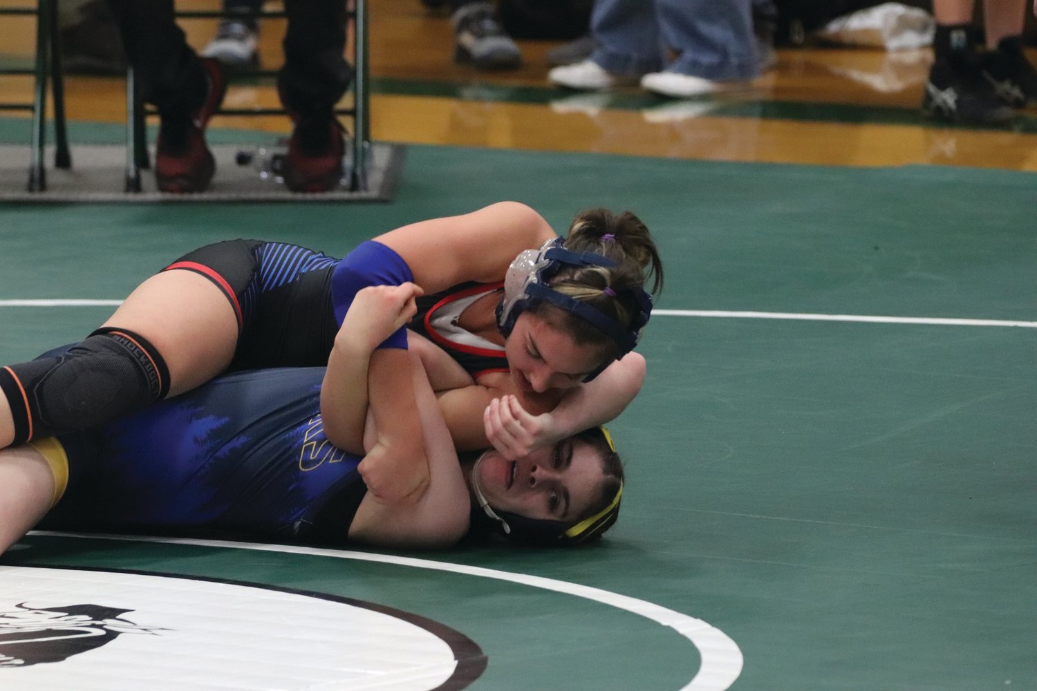 EJ senior Chloe Lampert finishes off her Forks High opponent using the “barbed wire” move, winning by fall. Lampert is a natural leader on the wrestling team, according to the coaching staff.