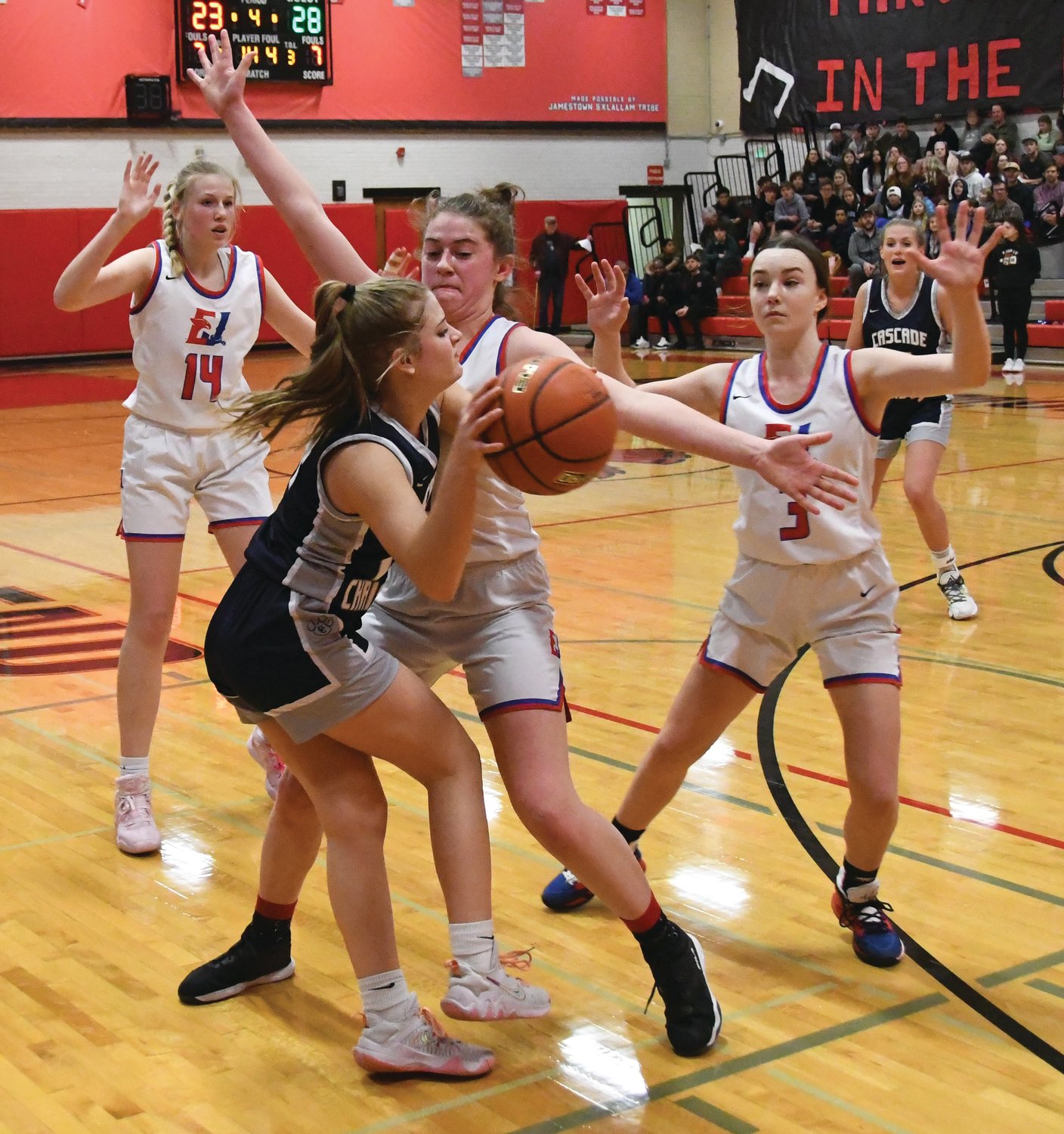 EJ’s Addy Asbell (center), Abbie Liske (left), and Kay Botkin (right) apply defensive pressure to a Cougar player during the fourth period.