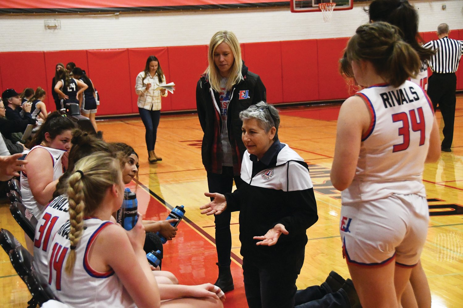 Rivals Head Coach Lorraine Rimson speaks with her girls after calling a timeout late into the game.