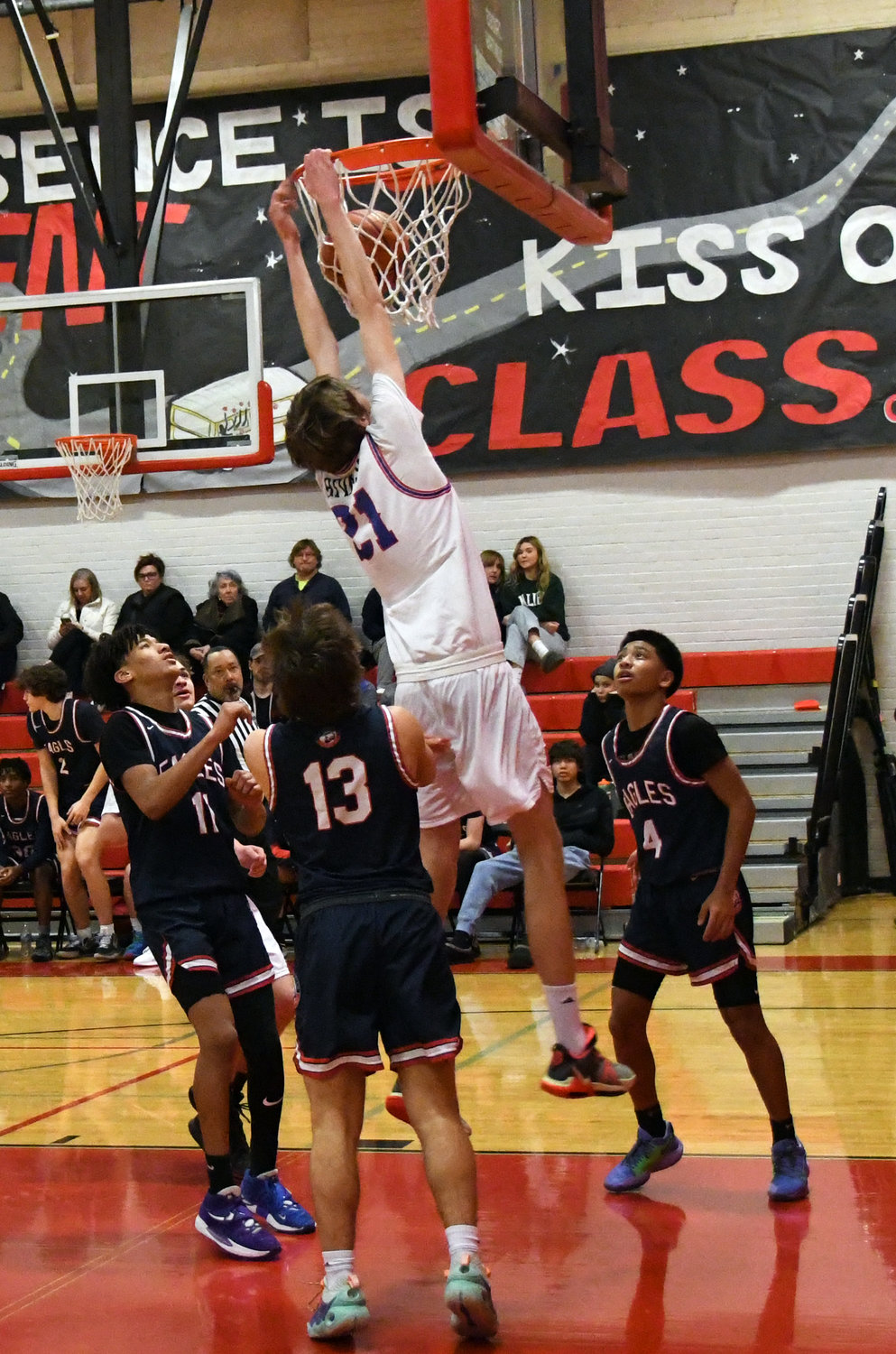 Rivals junior Stuart Dow slams down a putback dunk, inspiring a wave of momentum and a roaring crowd in the first half.