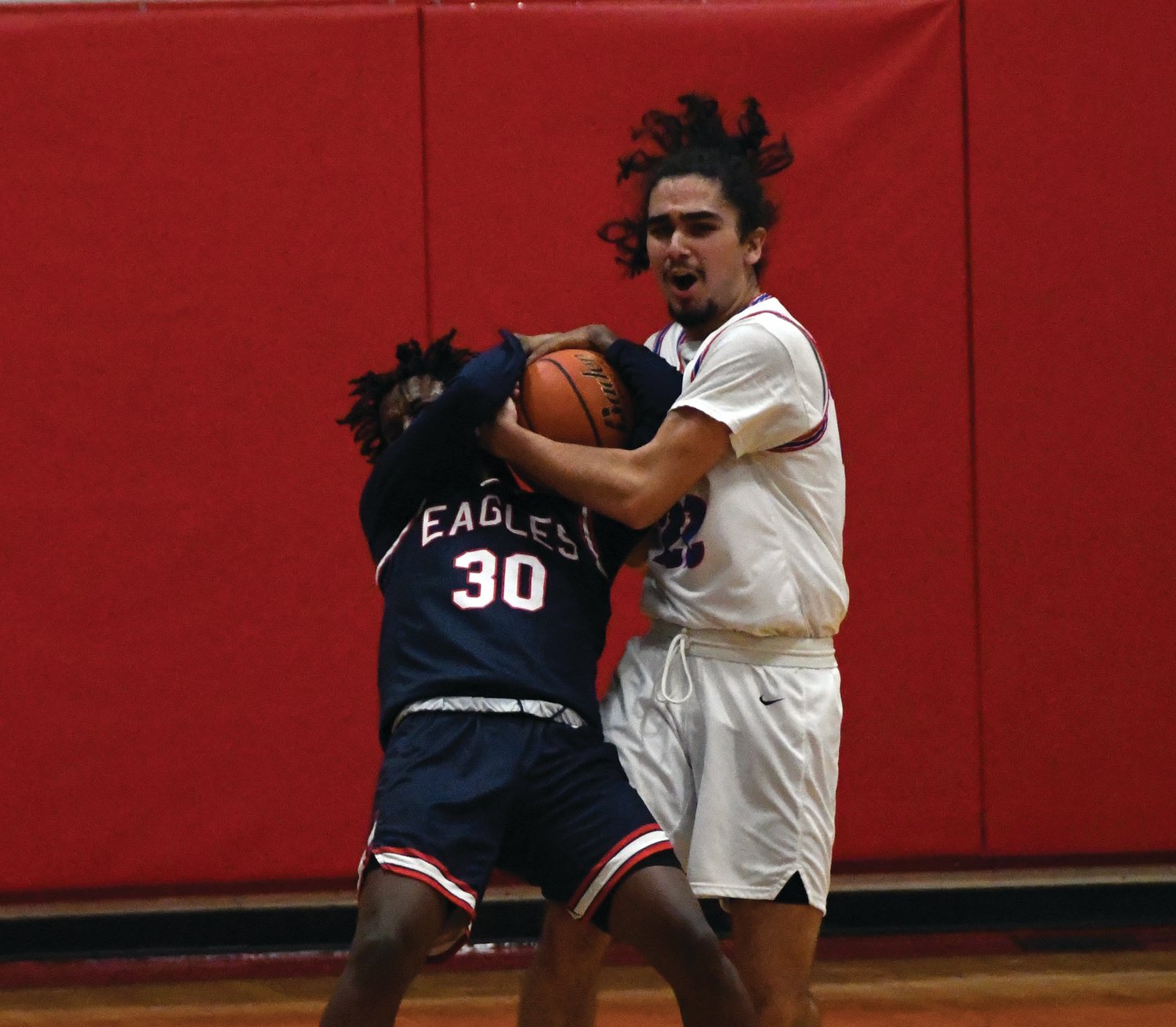 EJ senior Lorenzo McCleese jostles with a Life Christian Academy player for possession of the basketball.