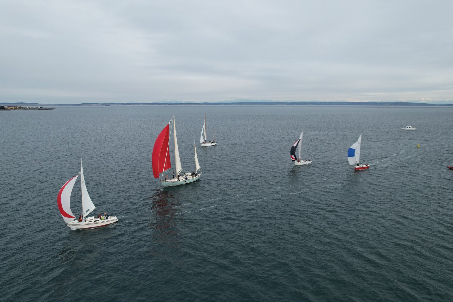 Regatta racers float through the three-buoy, triangular race Saturday, with clear weather offering open views in Port Townsend Bay.