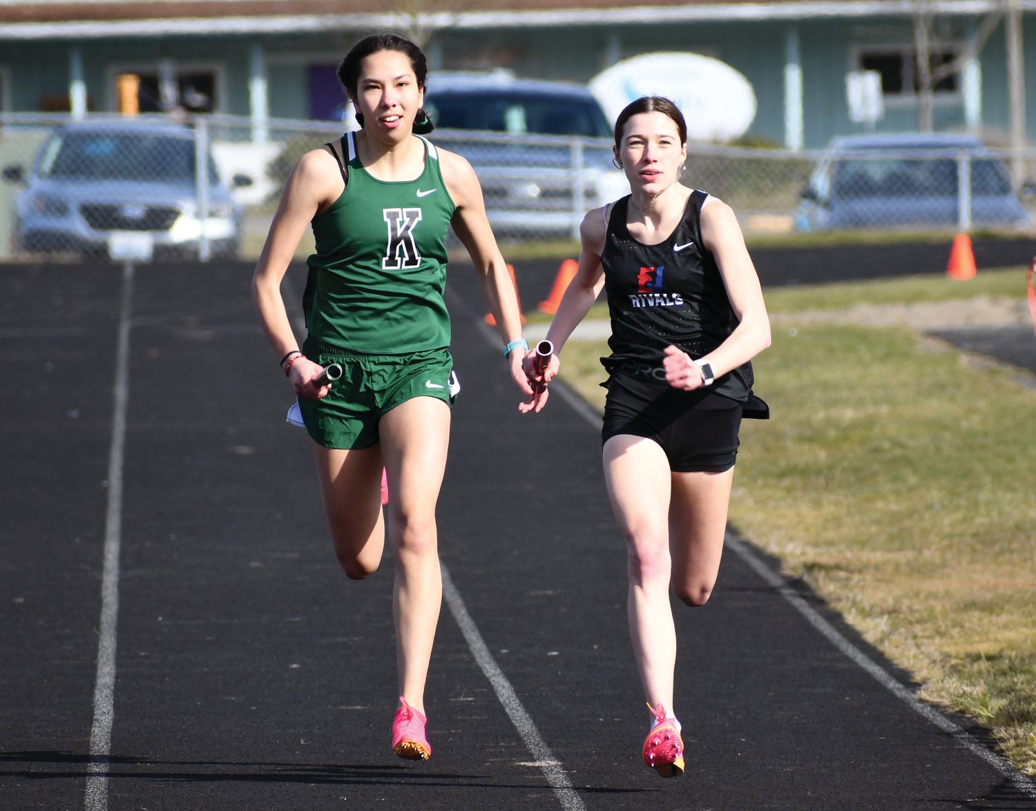EJ junior Aliyah Yearian runs neck-and-neck with Klahowya junior Amelia Mayes during the girl’s 1600-meter race, which Yearian won with a time of 5:21.28.