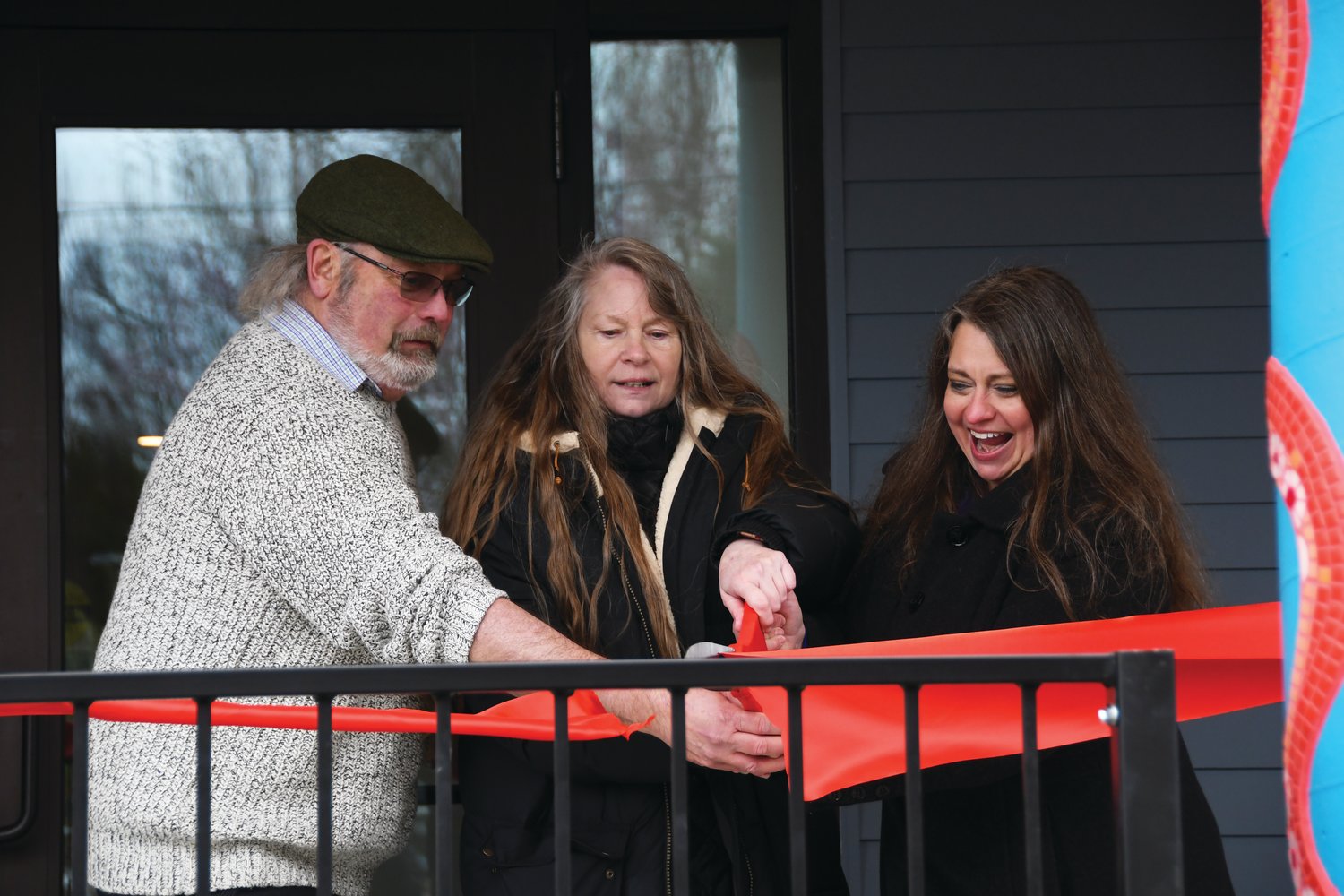 Dale Wilson, Kathy Morgan, and Cherish Cronmiller of OlyCAP cut the ribbon to open 7th Haven after six years of hard work.