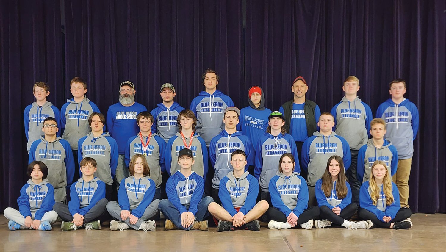 Wearing their Blue Heron garb, the middle school squad poses together at the end-of-year celebration with the highest team turnout ever with 24 kids participating.