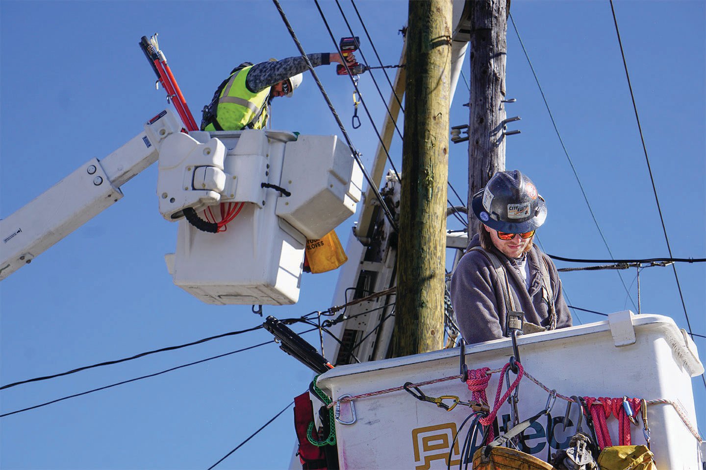 Jefferson County Public Utility District line crew members Jonathan Dehnert (left) and Keith Halsey (right) complete a distribution pole changeout on Port Townsend’s Lawrence Street, replacing a rotting pole by utilizing the “cut and kick” technique.