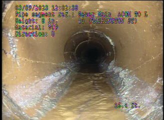 In a video probe screenshot taken near the Washington and Adams streets intersection, a collection of sediment has built up over time in the asbestos-concrete pipe, causing the sewer main to deteriorate and crack.