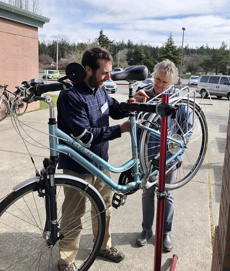 Volunteers work to repair a bicycle during a JeffCo Repair event last year. The series kicks off again this month in Brinnon. Courtesy photo